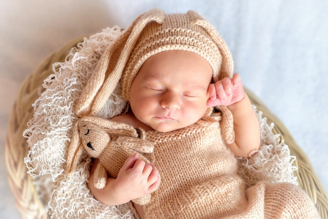 sleeping baby dressed in rabbit outfit