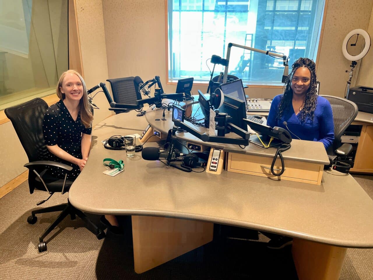 Dr. Alice Knoedler of Midwest Allergy and Asthma and Angela Davis of MPR news sit across from one another at a table in MPR's studio