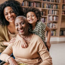Young girl, adult woman, and senior woman sitting together