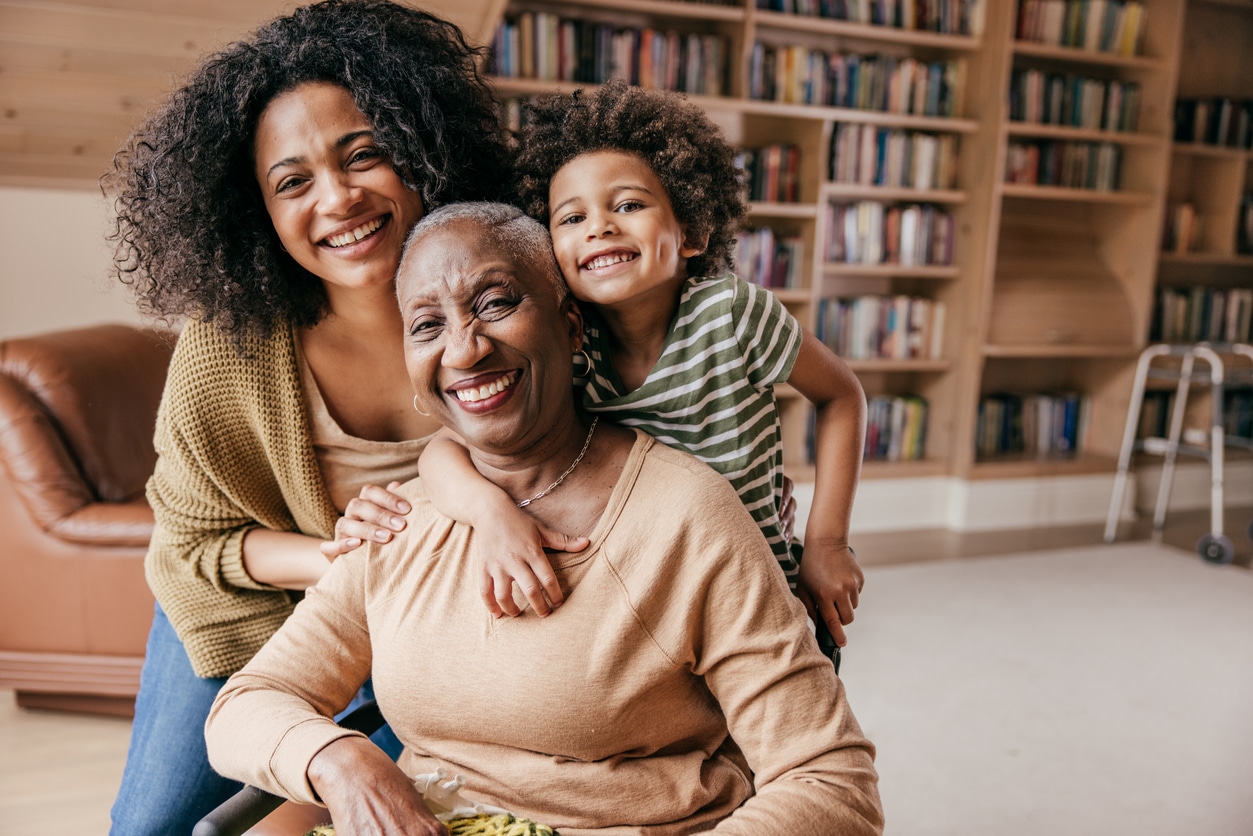 Young girl, adult woman, and senior woman sitting together.