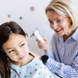 ENT examining a young girl's ear