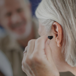 Woman putting in a hearing aid